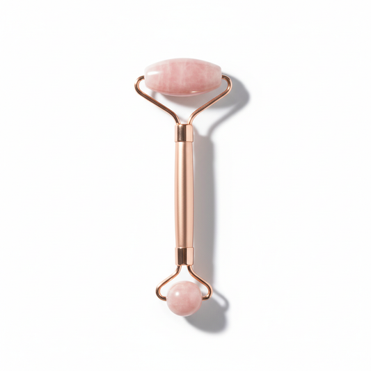 Elegant rose gold facial roller on white background